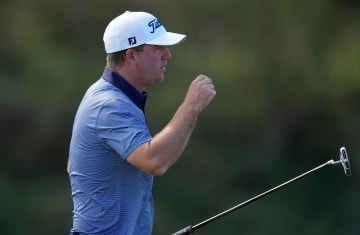 Tom Hoge acknowledges the gallery after his round from the 18th green.