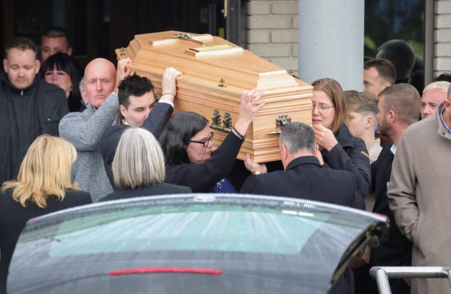 Friends and mourners grieve as the coffins are removed following the funeral of Philip and Kim English and their sons Callum (12) and Jayden (9) at the Sacred Heart Church.